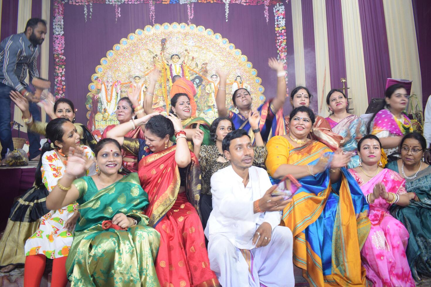 Delhi, India, July 02,2024 - Devotees performing spiritual dance in front of Durga Idol, Durga Puja celebration at Kali Bari temple in Jhilmil Colony Delhi, Durga utsav festival in Oct 2023 photo