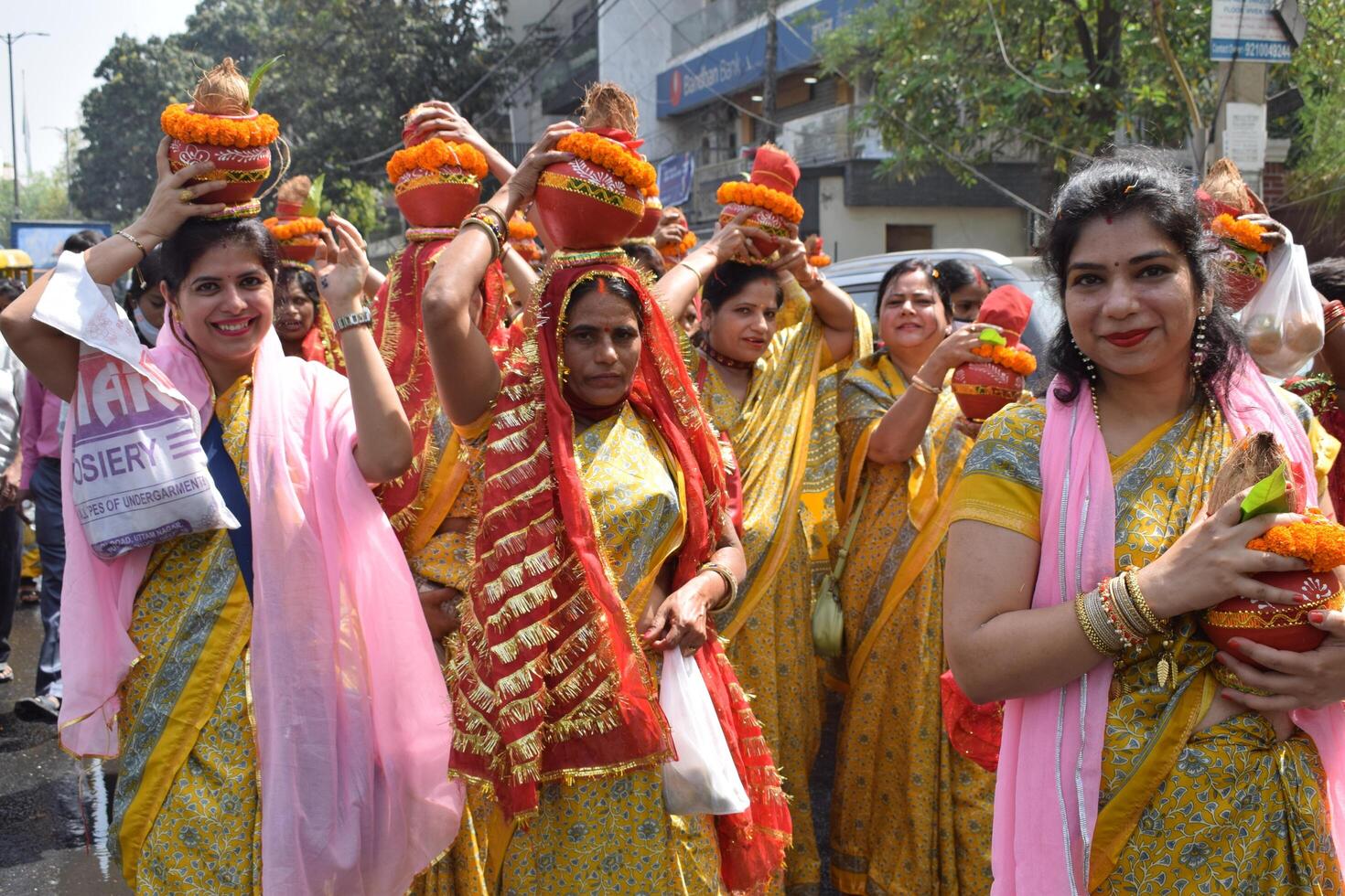 New Delhi, India July 25 2024 - Women with Kalash on head during Jagannath Temple Mangal Kalash Yatra, Indian Hindu devotees carry earthen pots containing sacred water with a coconut on top photo