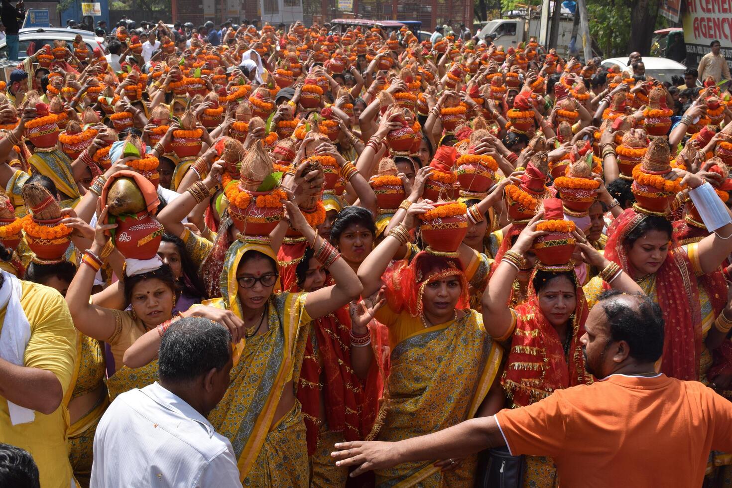 New Delhi, India July 25 2024 - Women with Kalash on head during Jagannath Temple Mangal Kalash Yatra, Indian Hindu devotees carry earthen pots containing sacred water with a coconut on top photo