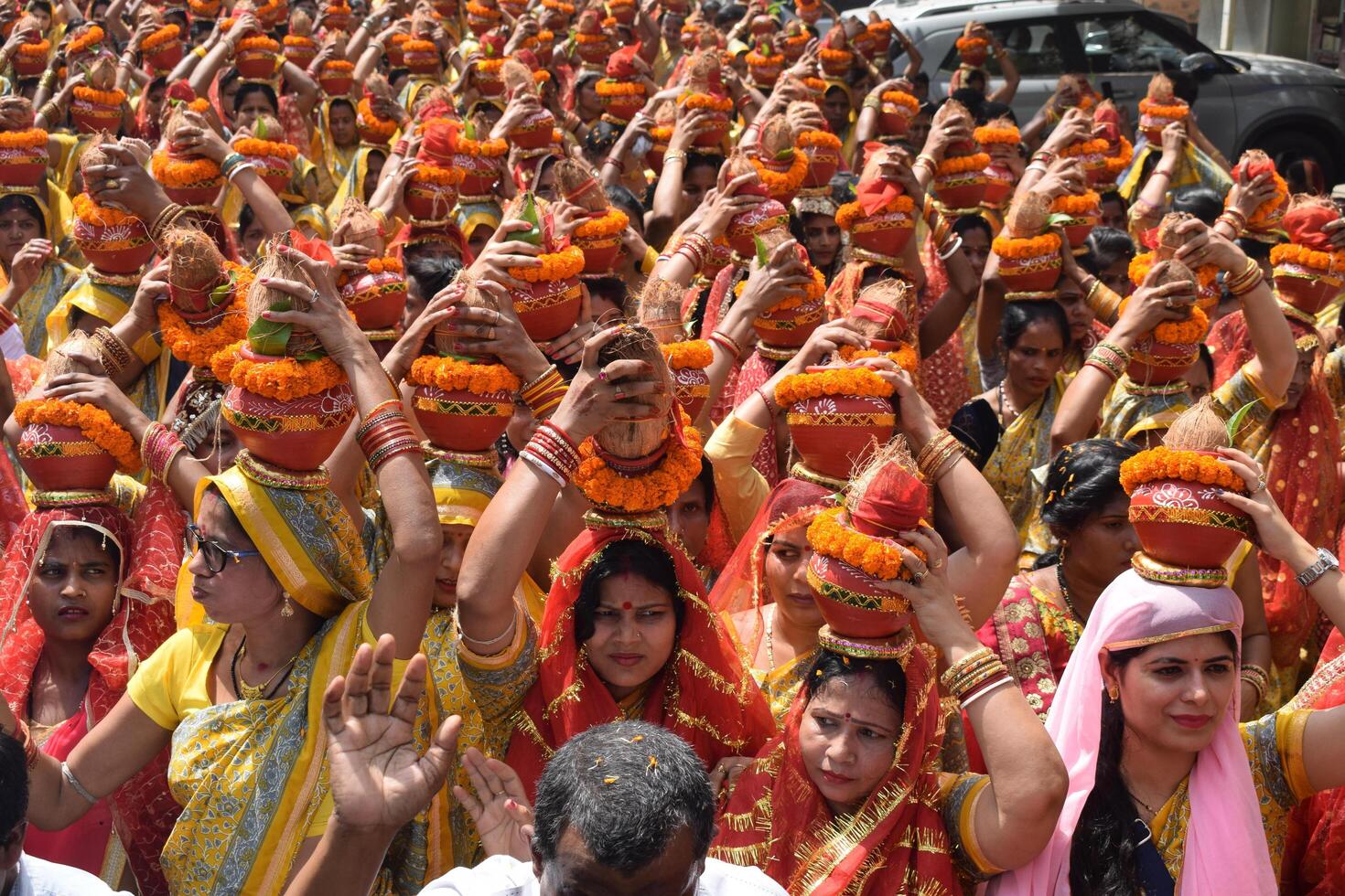 New Delhi, India July 25 2024 - Women with Kalash on head during Jagannath Temple Mangal Kalash Yatra, Indian Hindu devotees carry earthen pots containing sacred water with a coconut on top photo