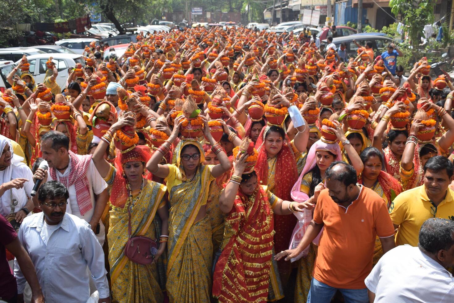 New Delhi, India July 25 2024 - Women with Kalash on head during Jagannath Temple Mangal Kalash Yatra, Indian Hindu devotees carry earthen pots containing sacred water with a coconut on top photo