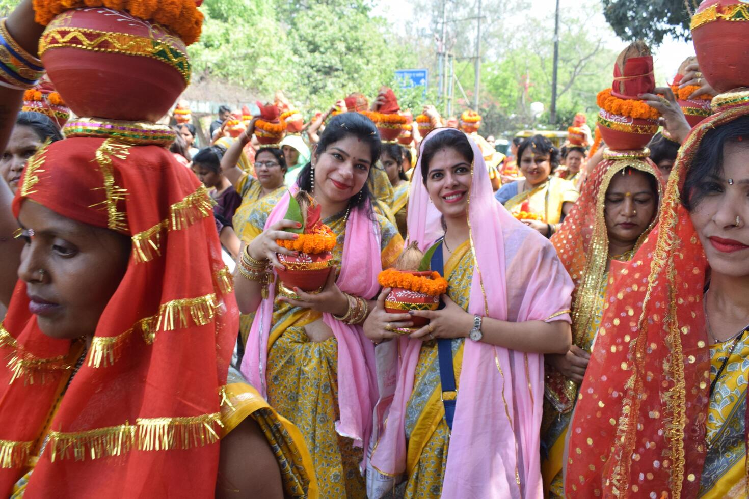 New Delhi, India July 25 2024 - Women with Kalash on head during Jagannath Temple Mangal Kalash Yatra, Indian Hindu devotees carry earthen pots containing sacred water with a coconut on top photo
