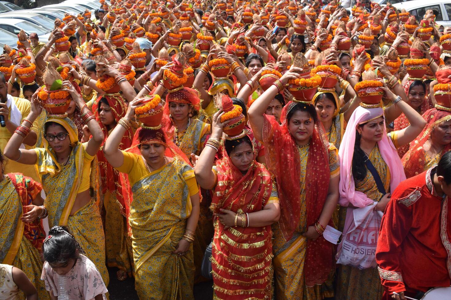 New Delhi, India July 25 2024 - Women with Kalash on head during Jagannath Temple Mangal Kalash Yatra, Indian Hindu devotees carry earthen pots containing sacred water with a coconut on top photo