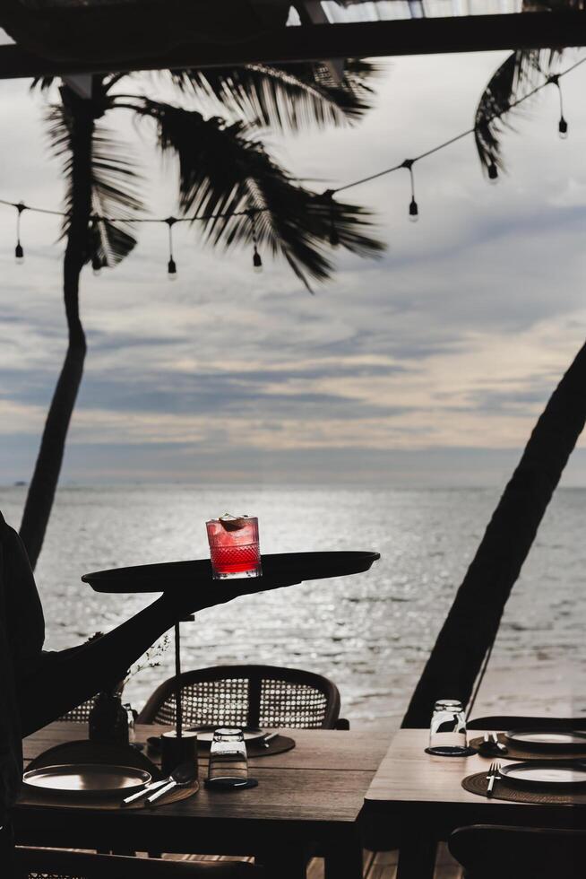 Waiter serving cocktail dink on a tray. photo