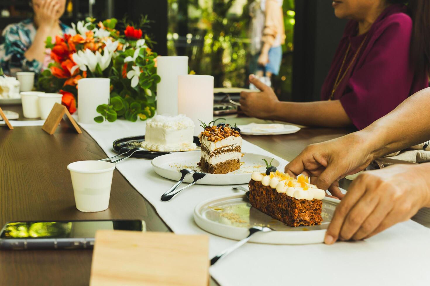 Waitresss serving slice of cake on the table in cafe. photo