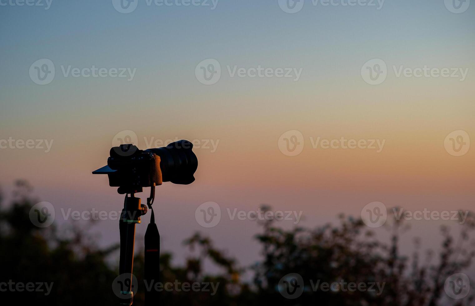 Photographer sets up a camera to capture the view of a traveler, a nature lover, peace and relaxation in nature. photo