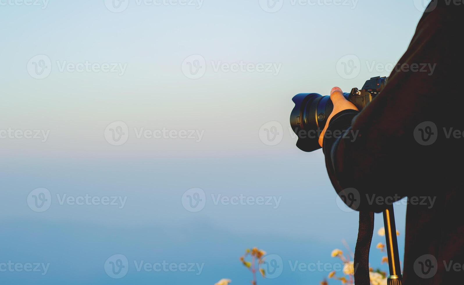 Photographer sets up a camera to capture the view of a traveler, a nature lover, peace and relaxation in nature. photo