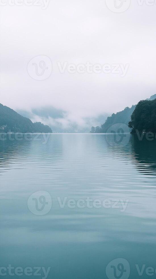 A calm lake with mountains in the background photo