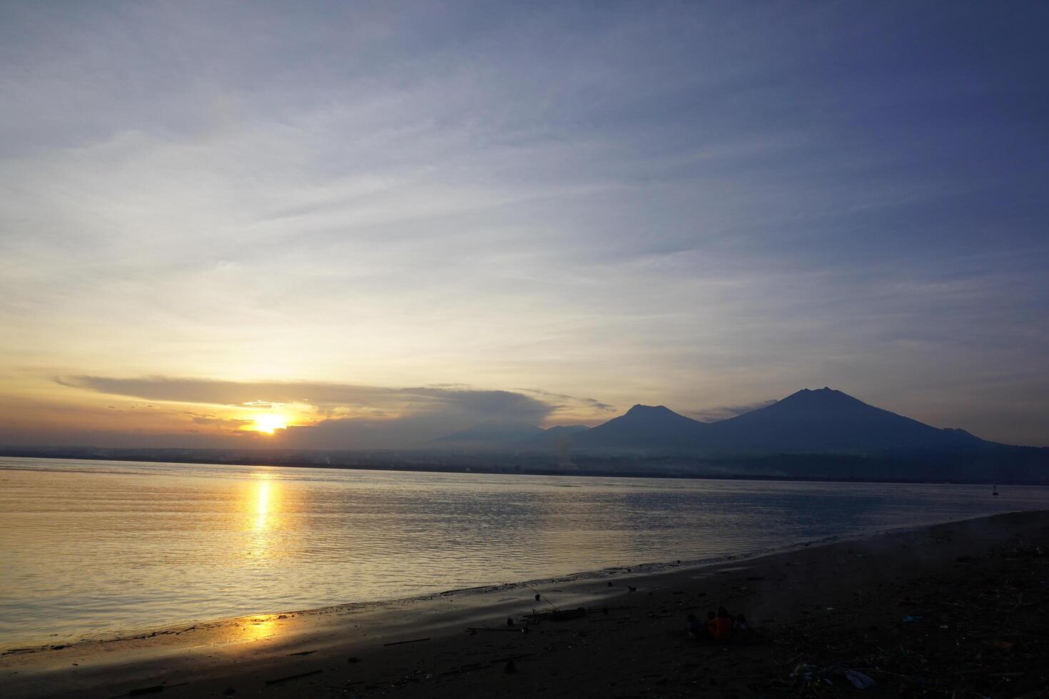 A beach with a mountain in the background photo