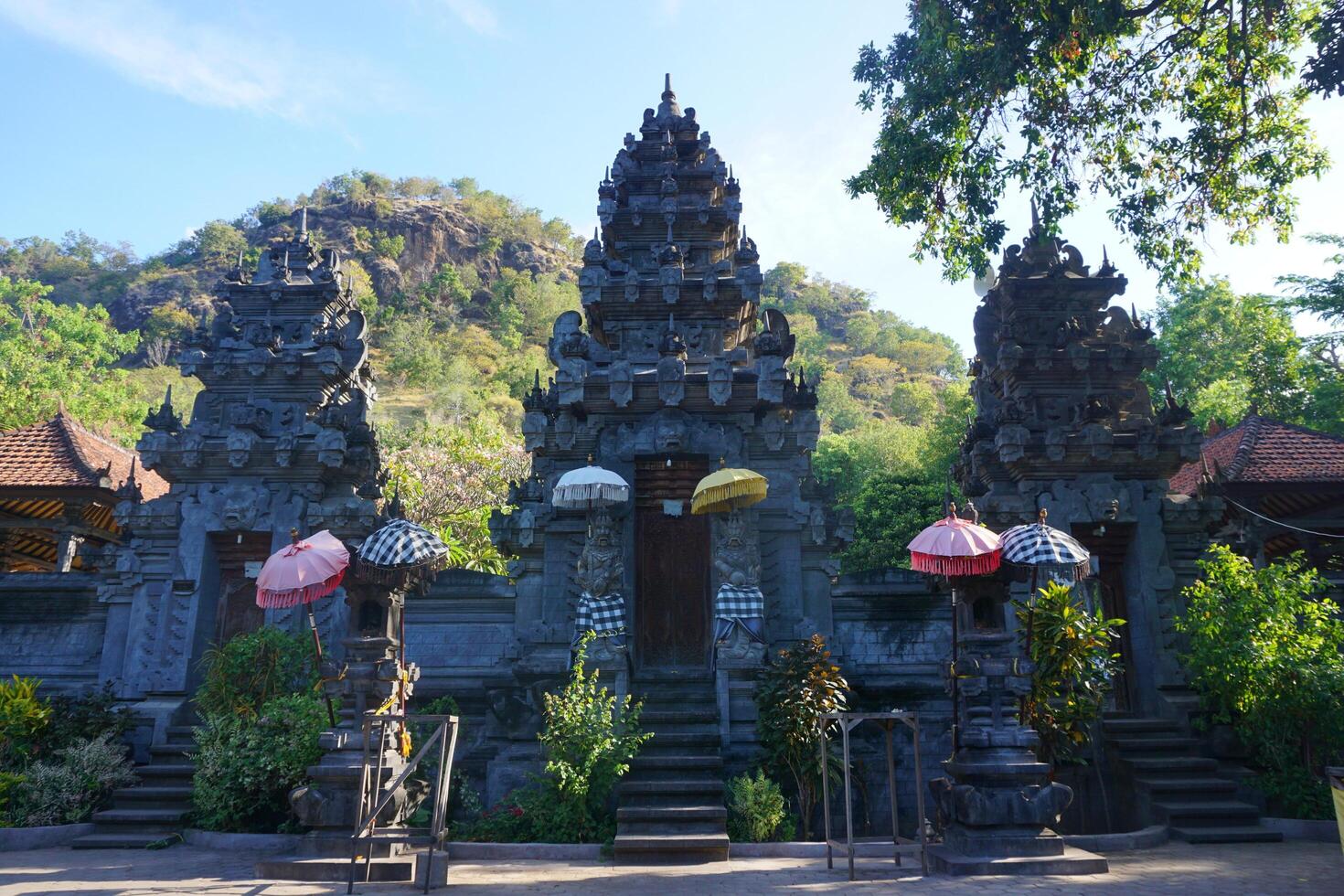 A group of people standing in front of a temple photo