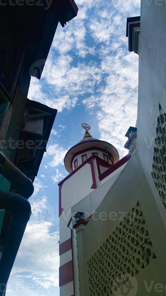 view of the mosque dome from below with a blue sky background. photo