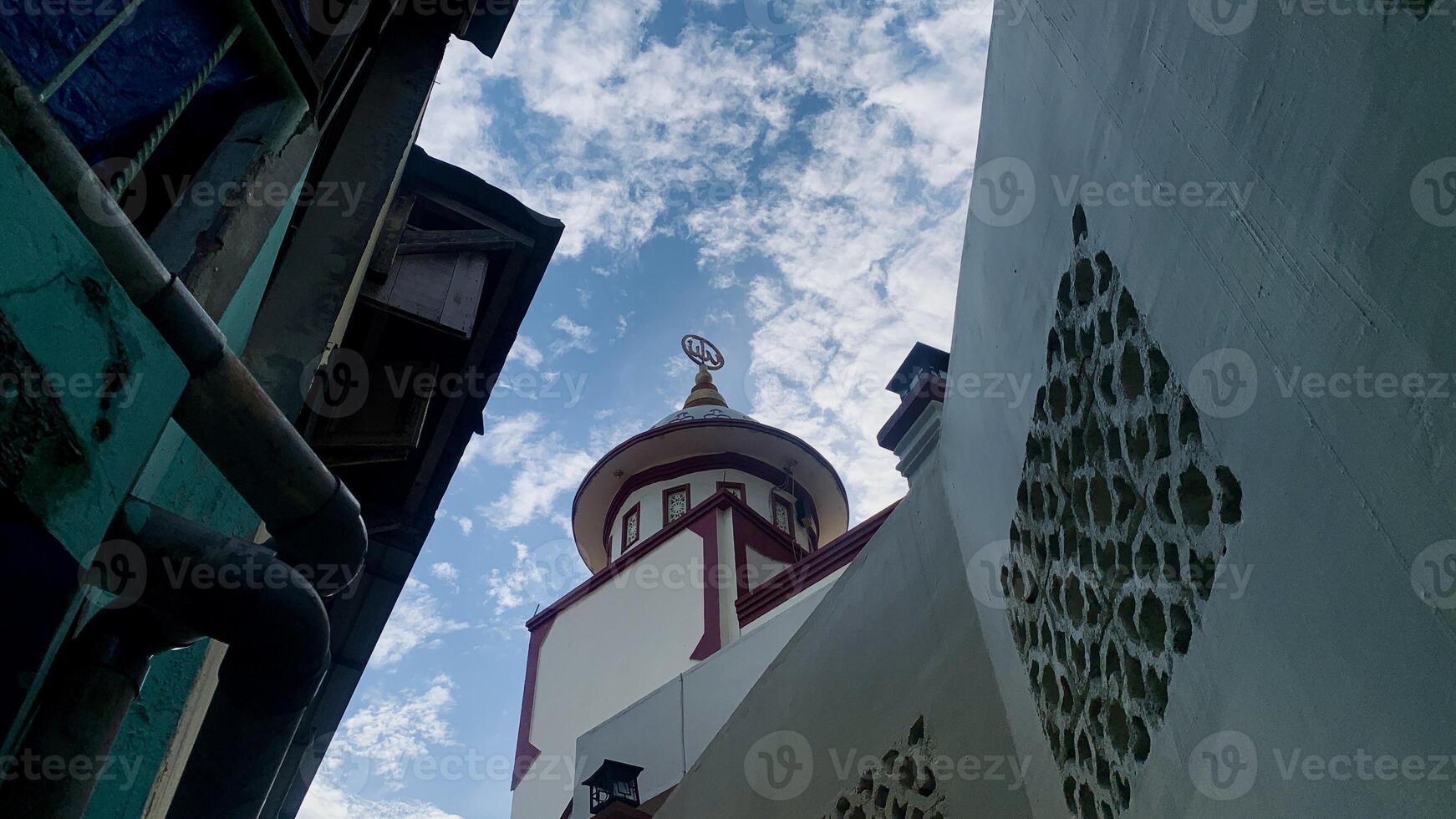 view of the mosque dome from below with a blue sky background. photo