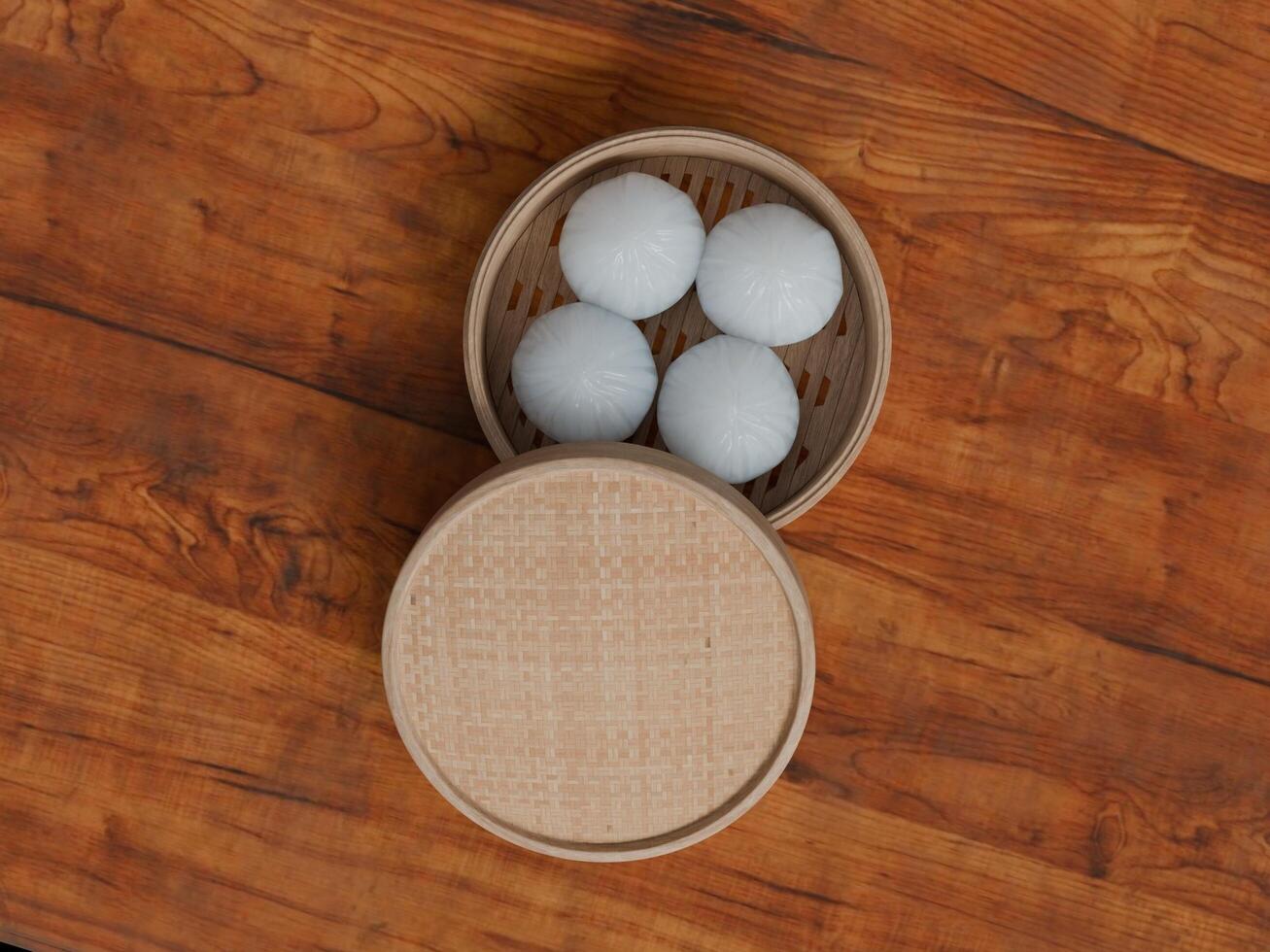 Three eggs in a bamboo container on a wooden table photo