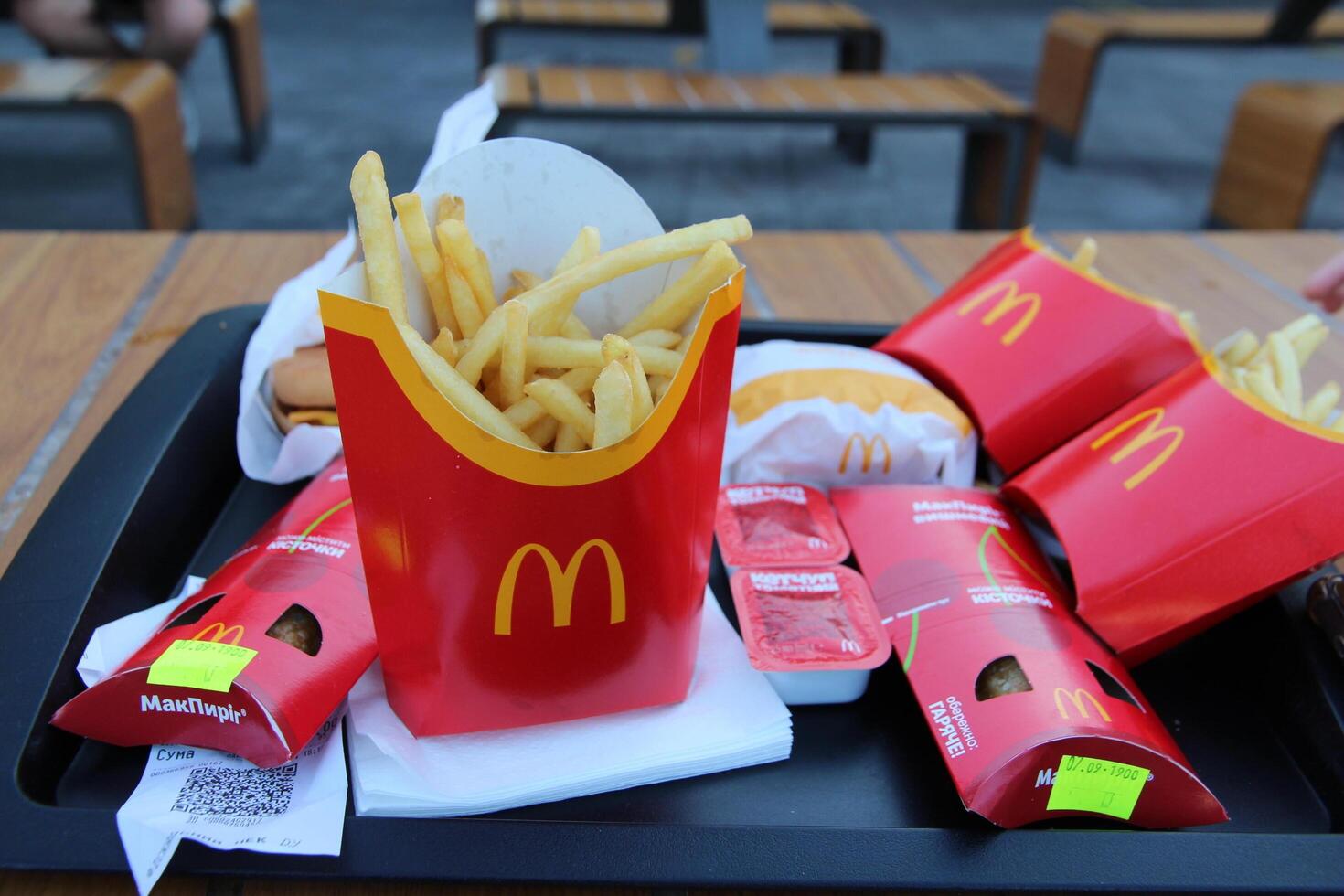Kyiv, Ukraine - September 7, 2024 Close-up of McDonald's food tray with fries, burger, cherry pie and sauces. Suitable for fast food promotions, social media and advertising campaigns photo