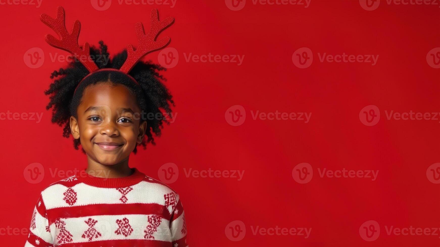 African American boy in winter sweater and Christmas reindeer antlers isolated on red background with copy space. Christmas New Year mockup. photo