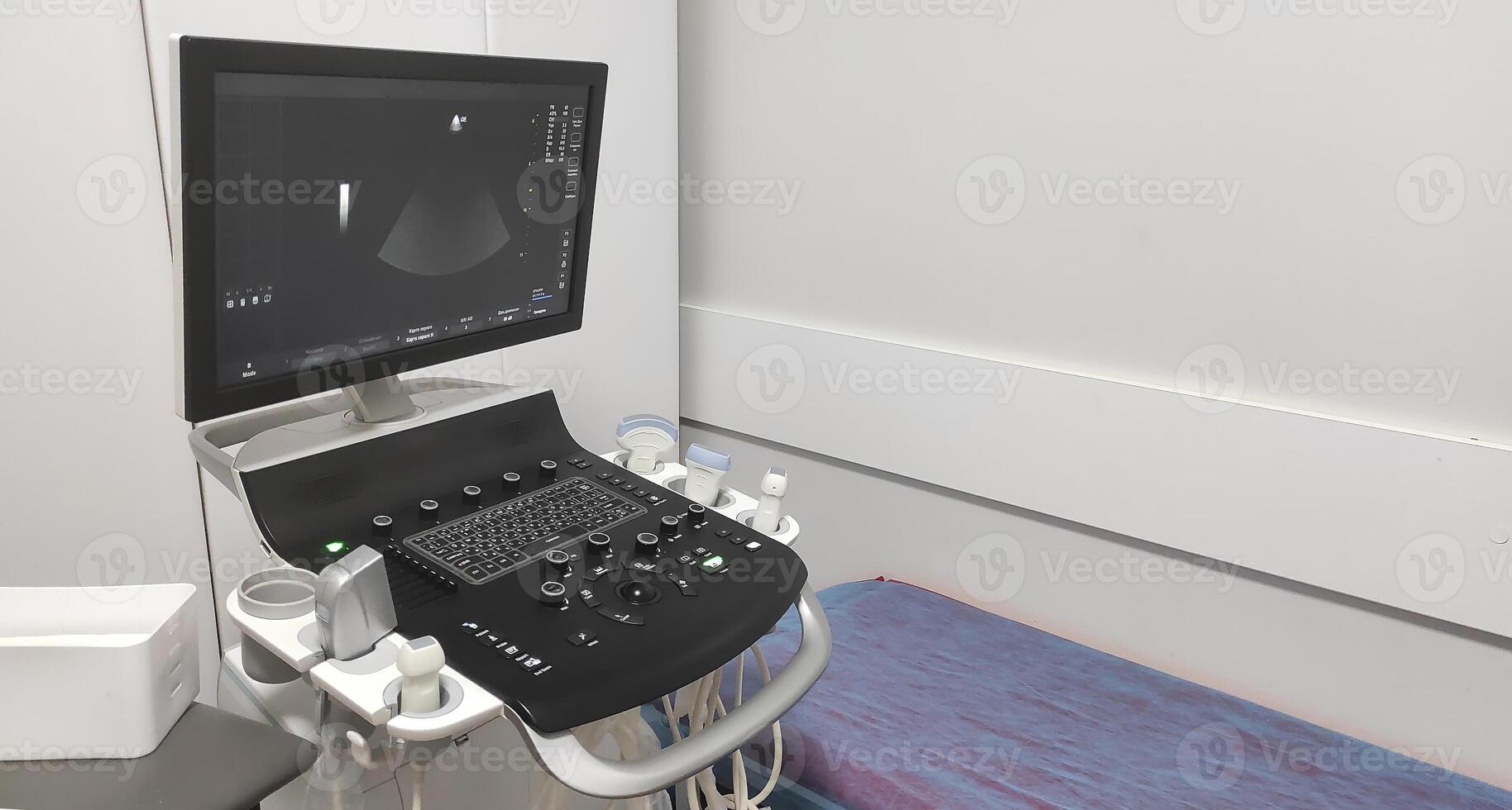 Modern ultrasound machine in a medical examination room, ready for diagnostic procedures. The display shows a real-time scan, with various probes and controls on the machine photo