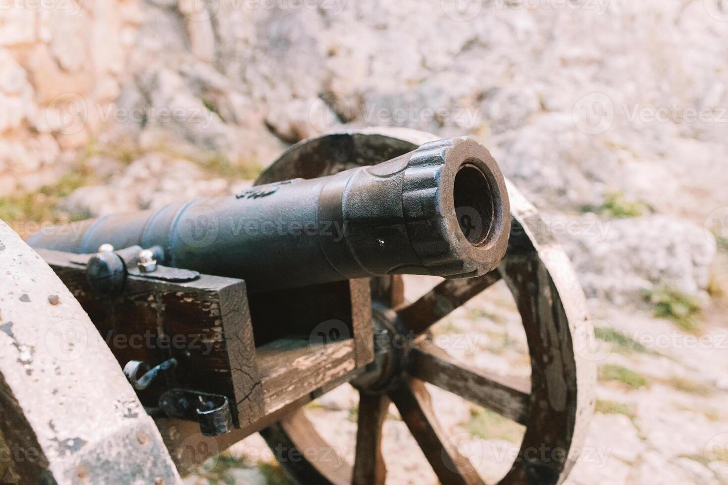Cannon on a carriage located on a white stone pedestal near the arsenal building in Mirow Castle. Sites of Poland. Architecture of World Tourism. photo