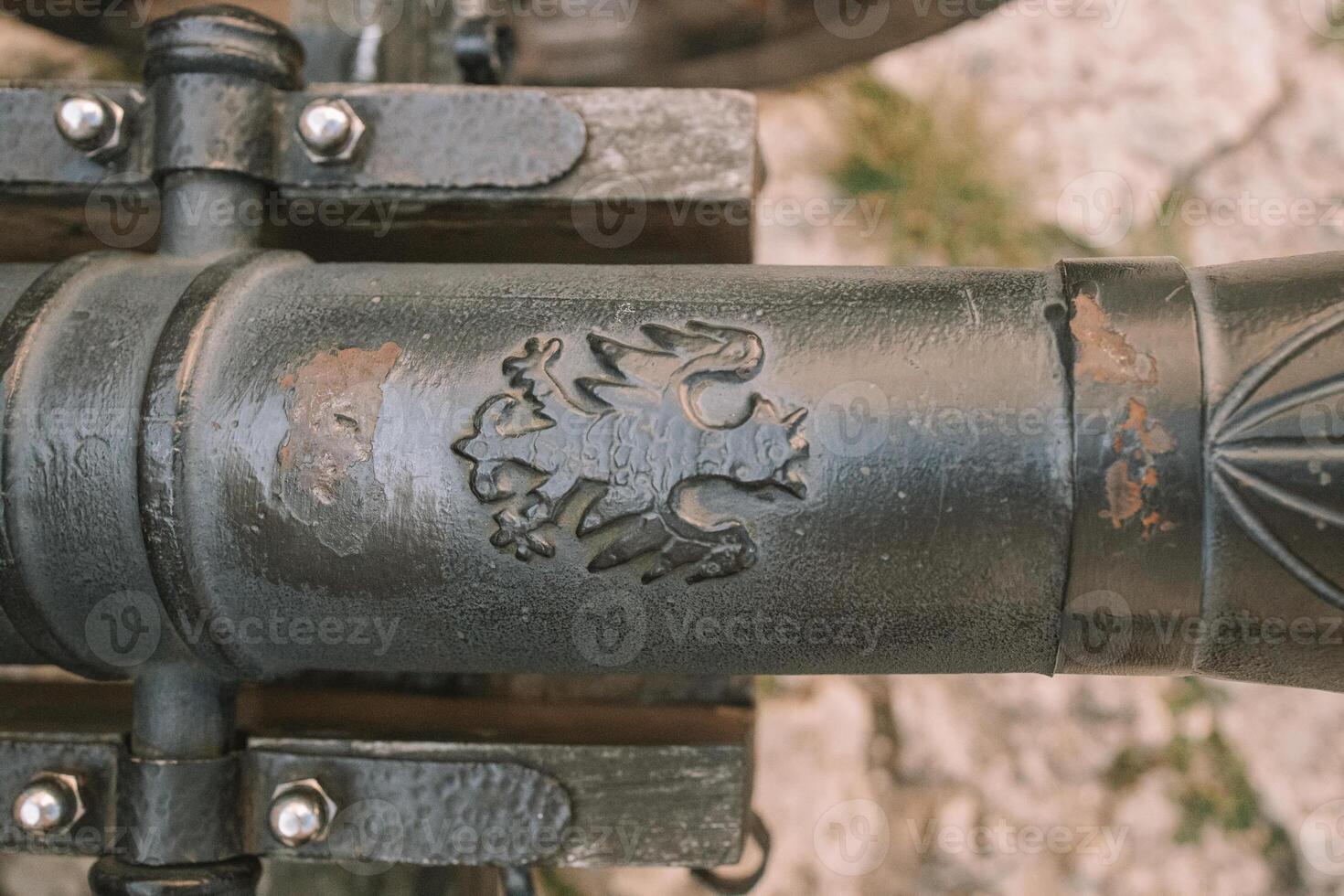Cannon on a carriage located on a white stone pedestal near the arsenal building in Mirow Castle. Sites of Poland. Architecture of World Tourism. photo