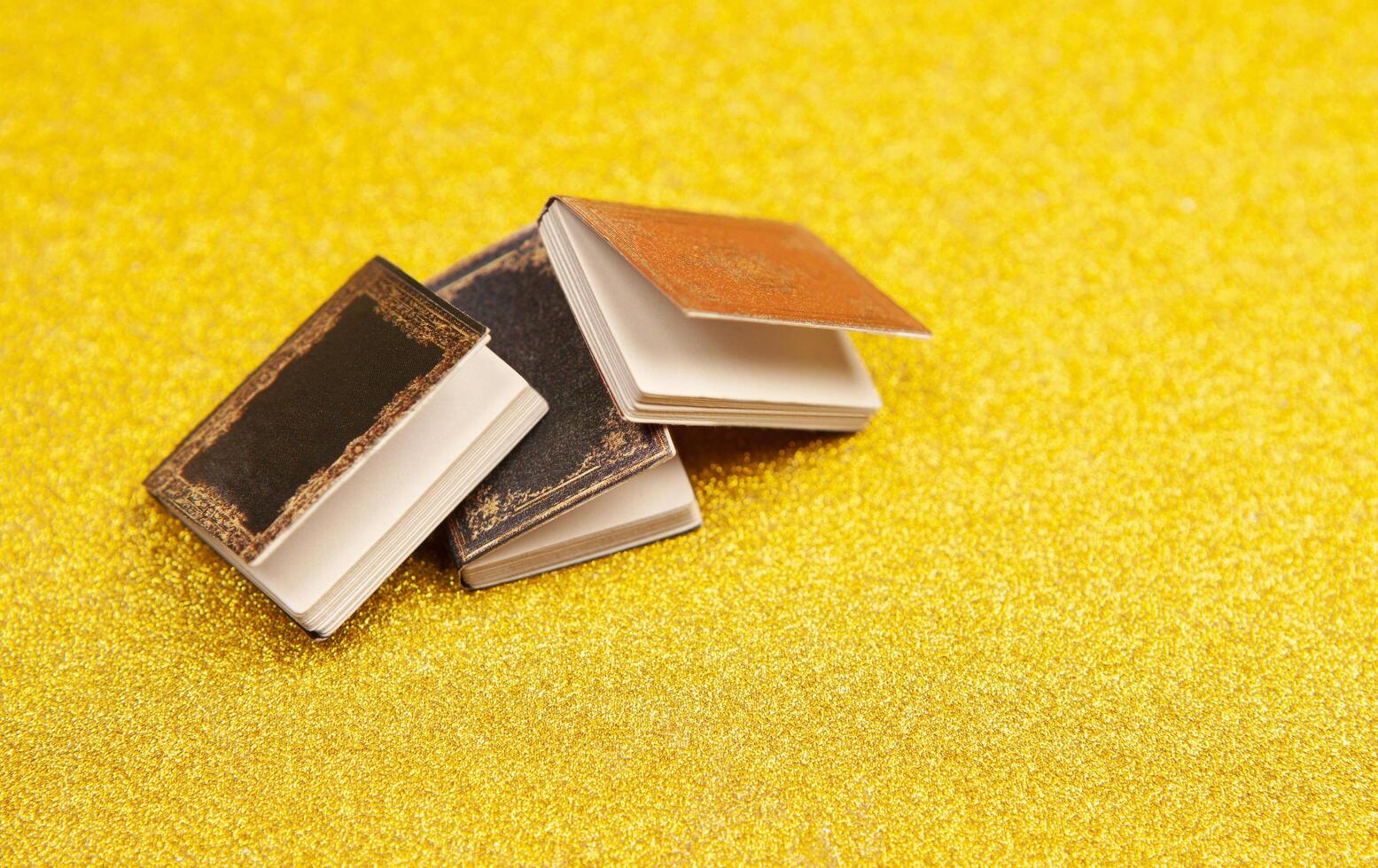 Three old books on a yellow background photo