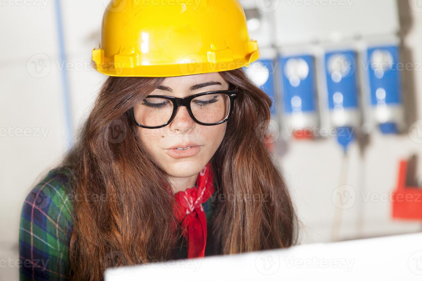 portrait of pretty engineer consult the computer in a steel mill photo