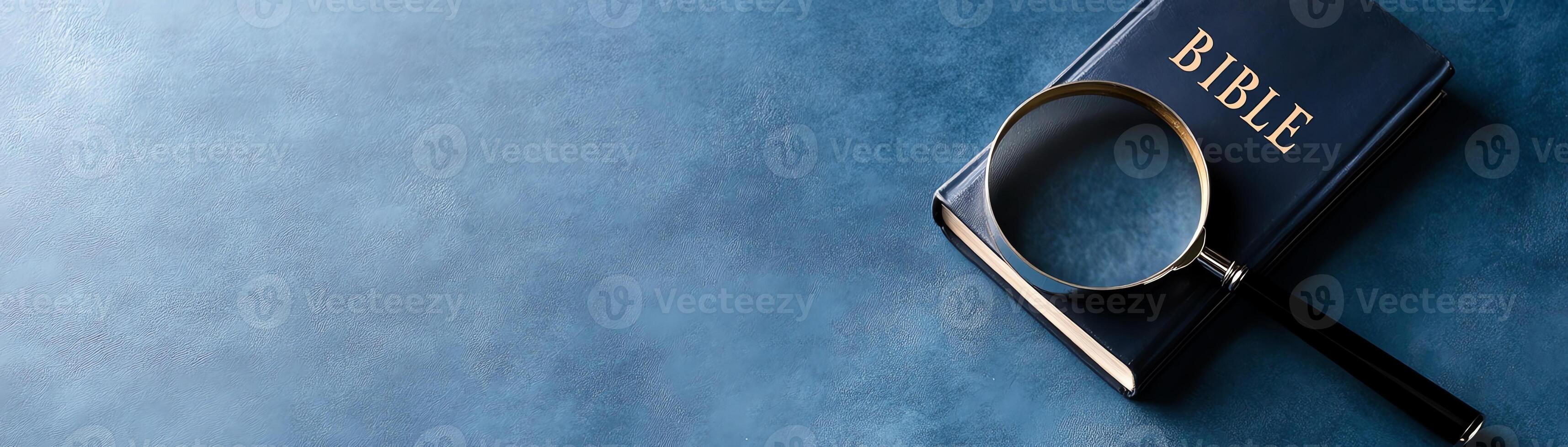 Magnifying glass on an open Bible, highlighting text. Conceptual image for study, exploration, and deeper understanding of religious scripture. photo