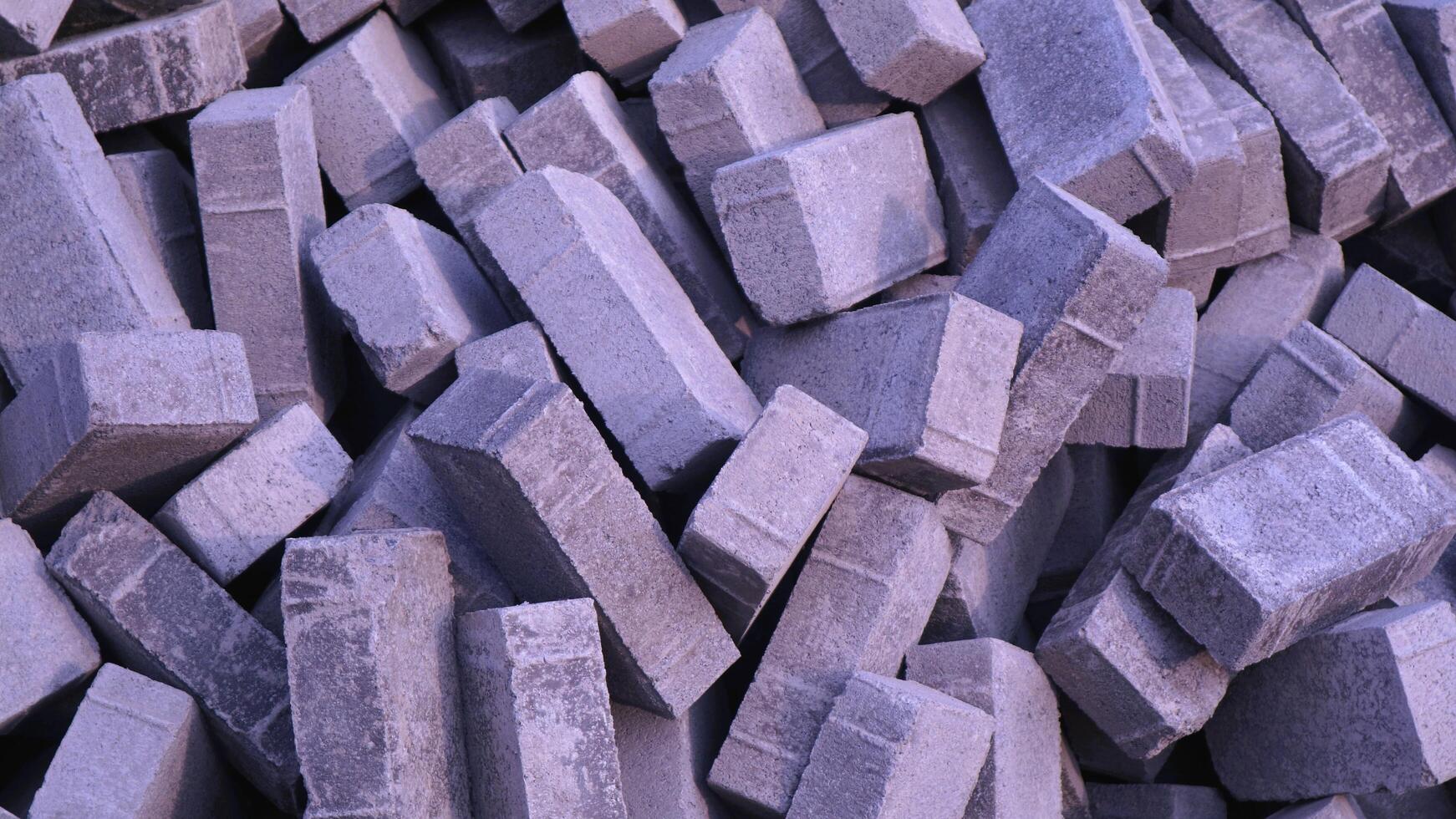 Pile of paving block, grey abstract textured background, copy space photo