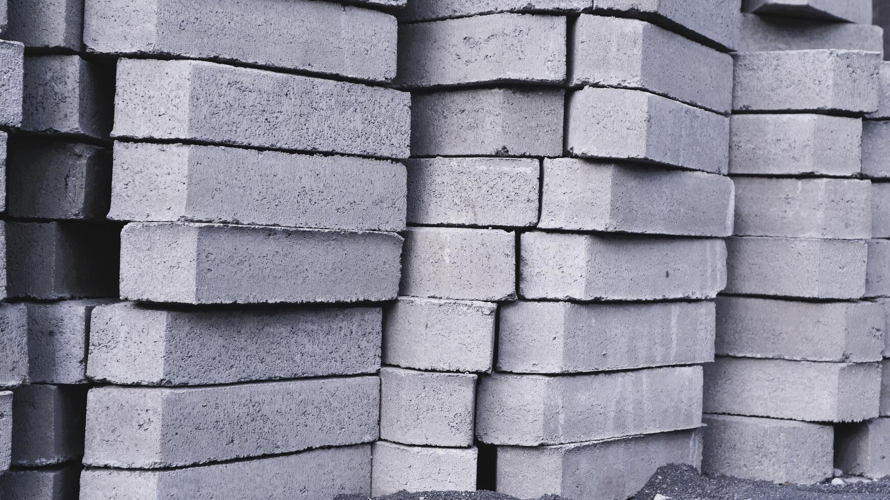 Pile of paving block, grey abstract textured background, copy space photo