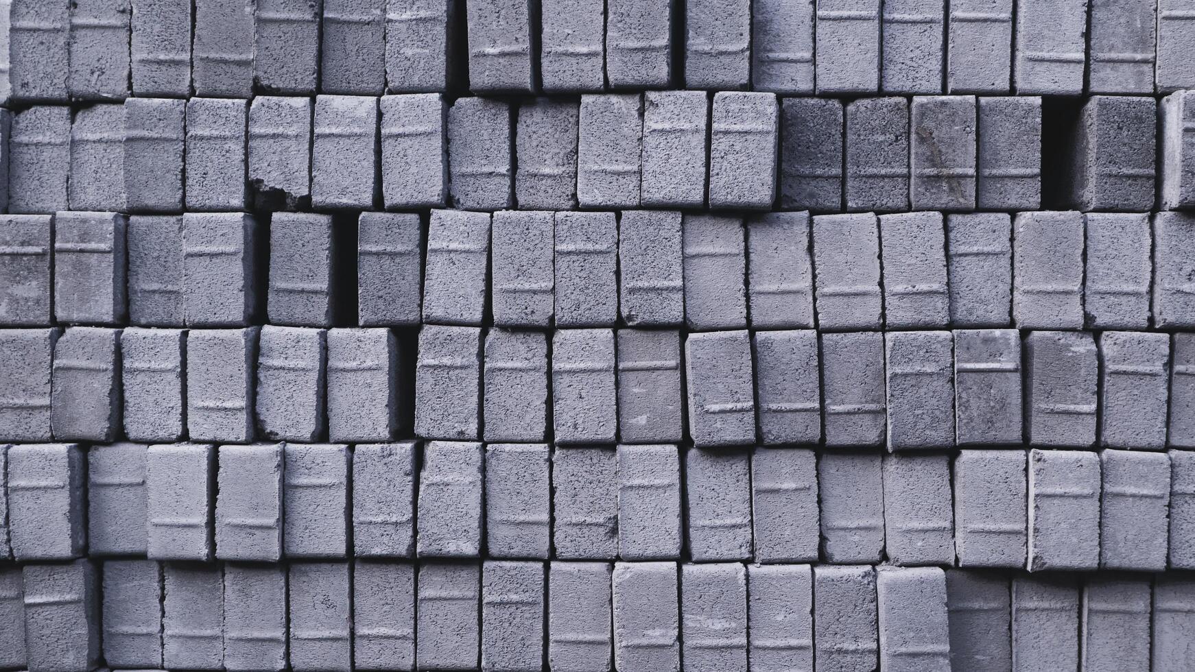 Pile of paving block, grey abstract textured background, copy space photo
