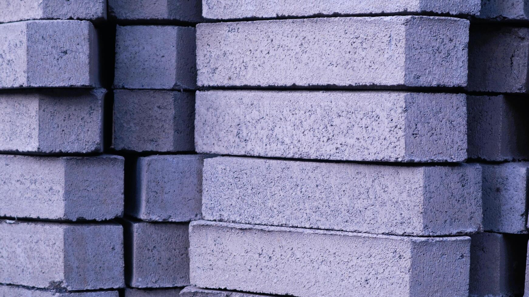 Pile of paving block, grey abstract textured background, copy space photo