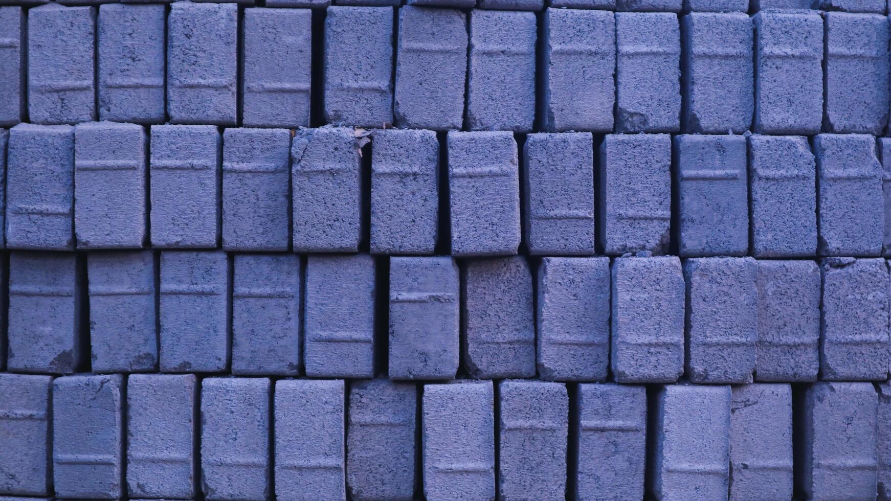 Pile of paving block, grey abstract textured background, copy space photo