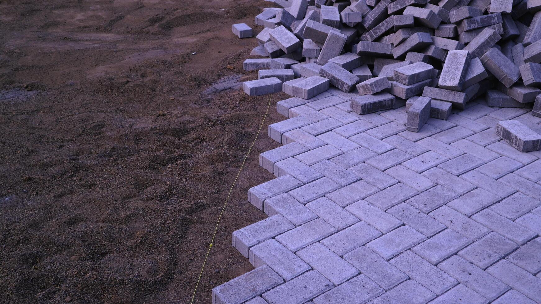 Pile of paving block, grey abstract textured background, copy space photo