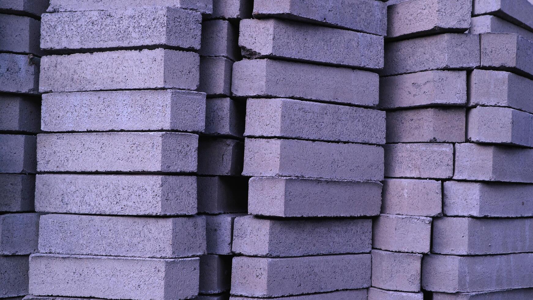 Pile of paving block, grey abstract textured background, copy space photo