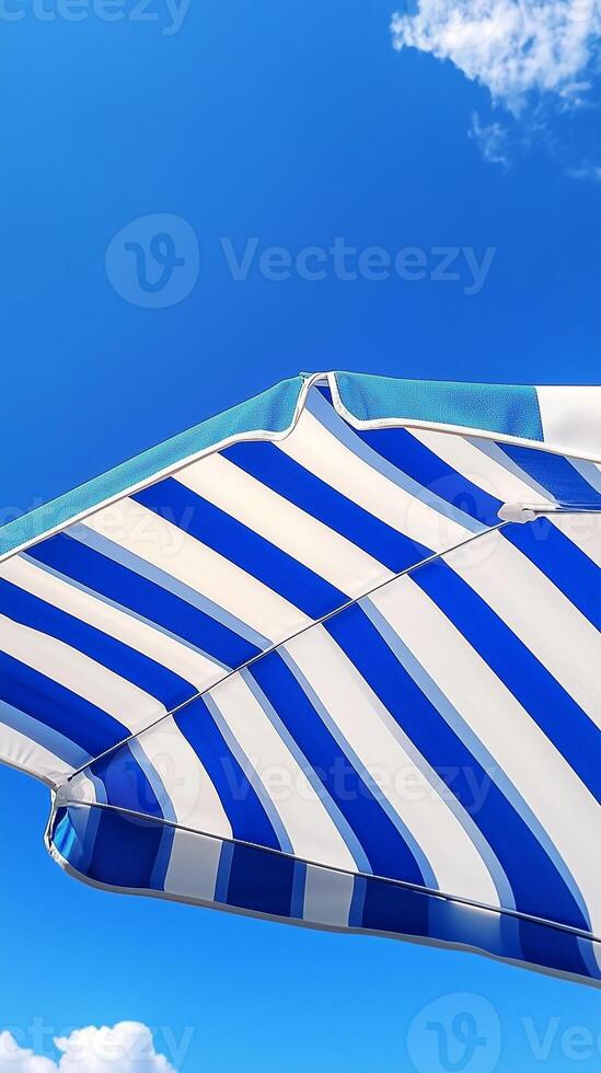 Umbrella blue and white beach for sunburn protection and blue sky bottom view photo