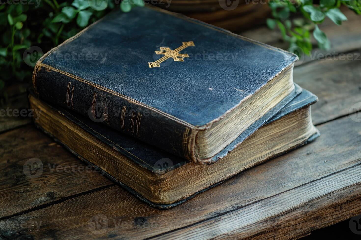Two antique books with gold decoration resting on wooden table photo