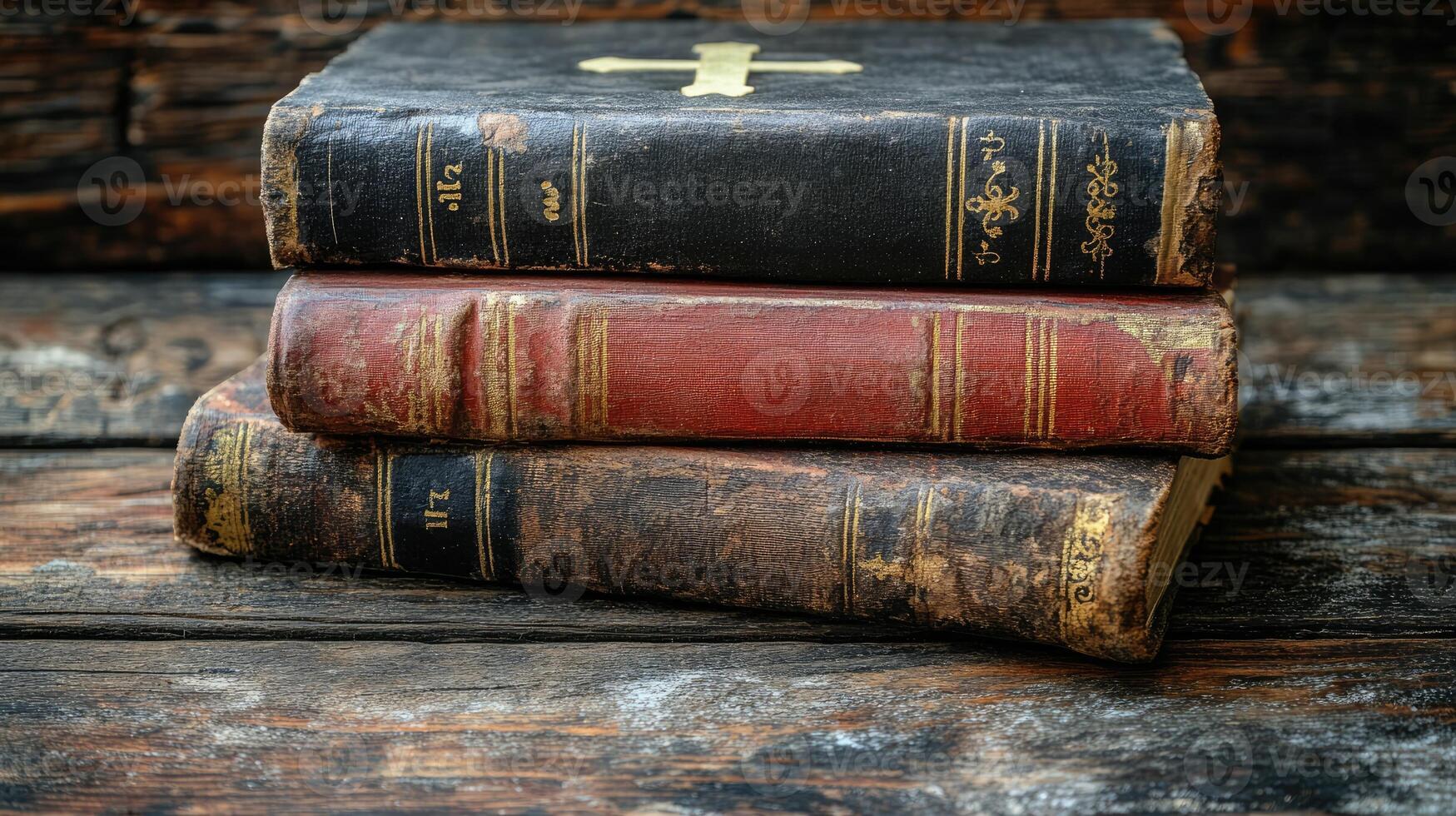 Old books with cross laying on wooden surface photo