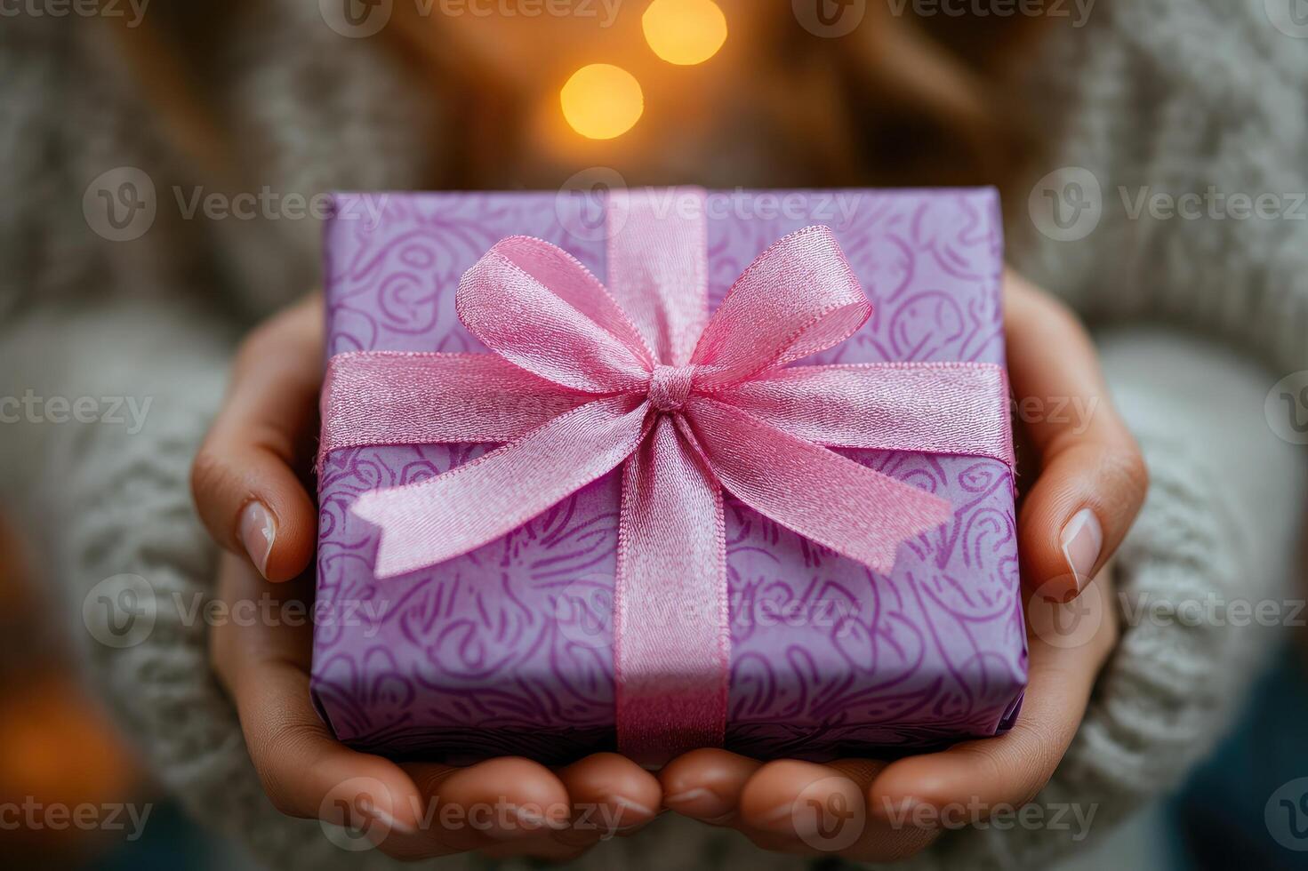 Woman holding a purple gift with pink ribbon photo
