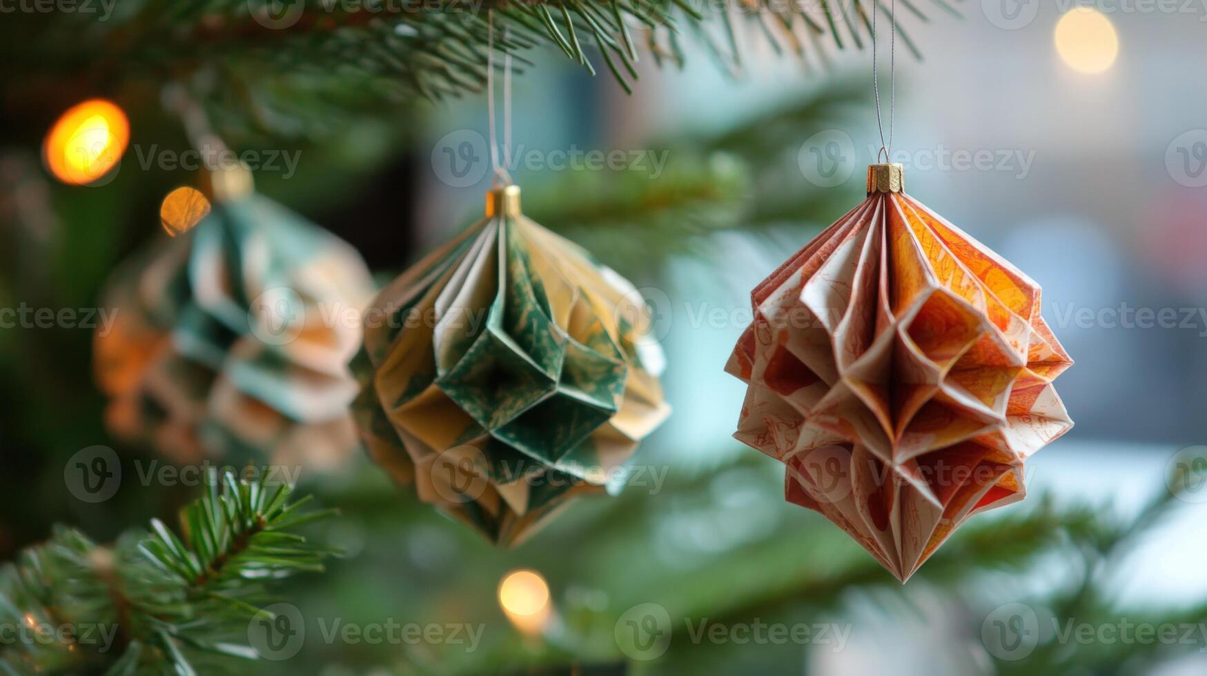 Three Paper Ornaments Hanging on a Christmas Tree Branch photo