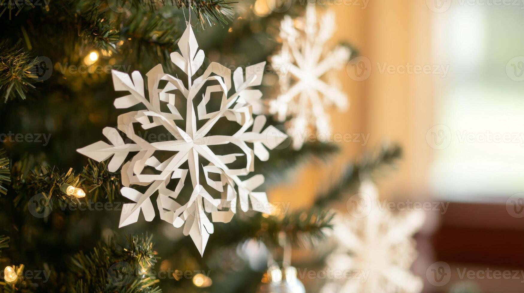 White Paper Snowflake Ornament Hanging on a Christmas Tree photo