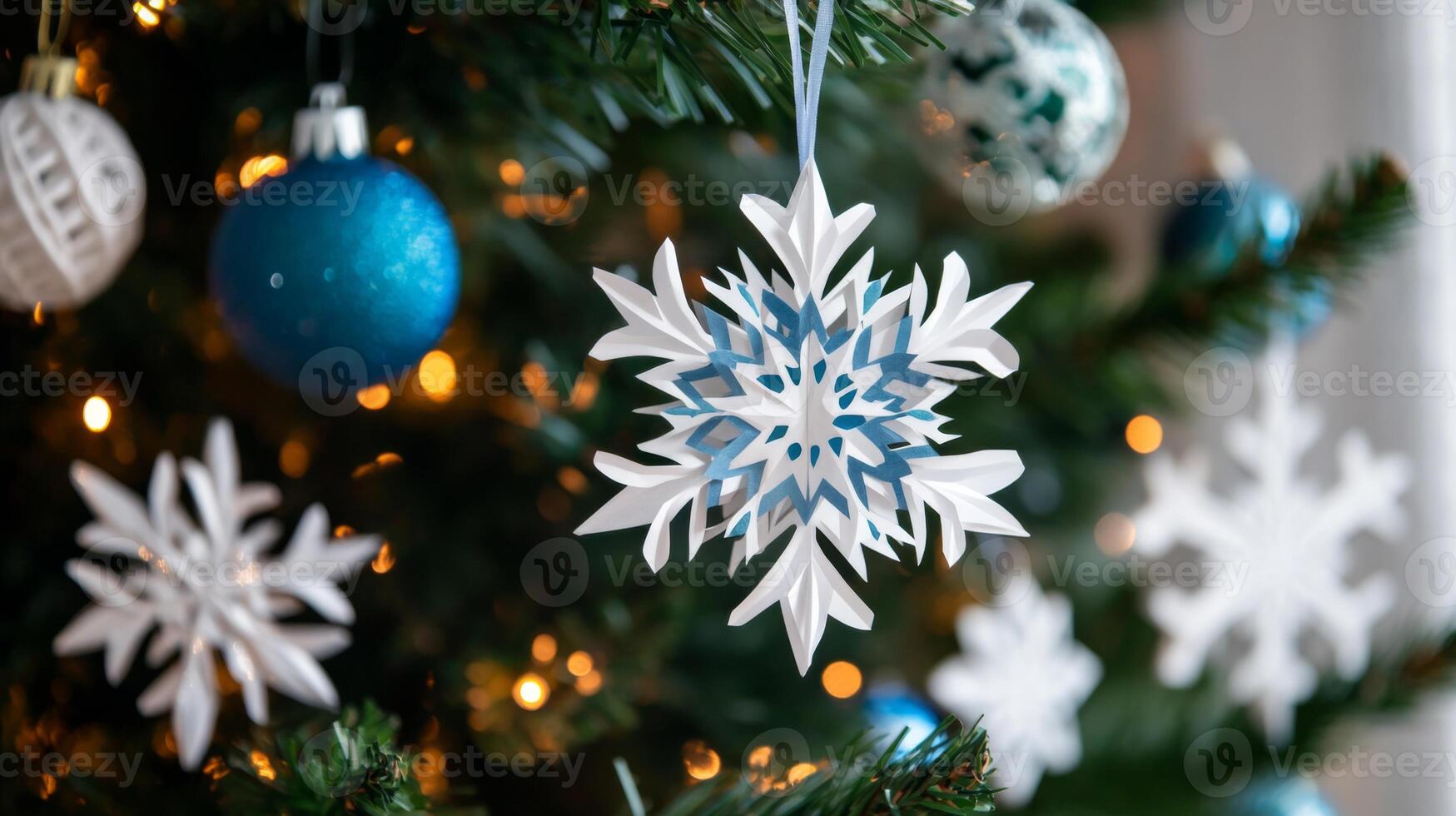 Paper Snowflake Ornament Hanging on Christmas Tree photo