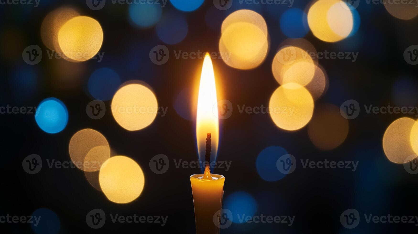 A Single Candle Burning with Bokeh Lights in the Background photo