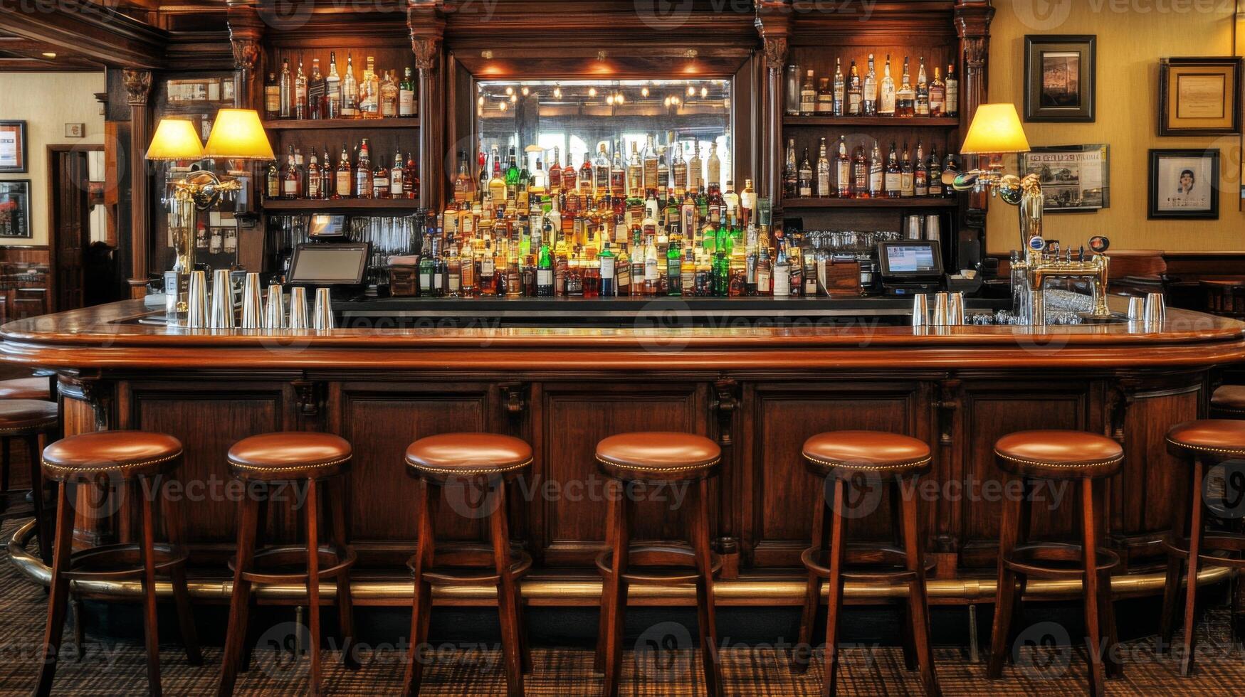 A classic wooden bar with a row of stools, a mirrored backsplash, and rows of liquor bottles. photo