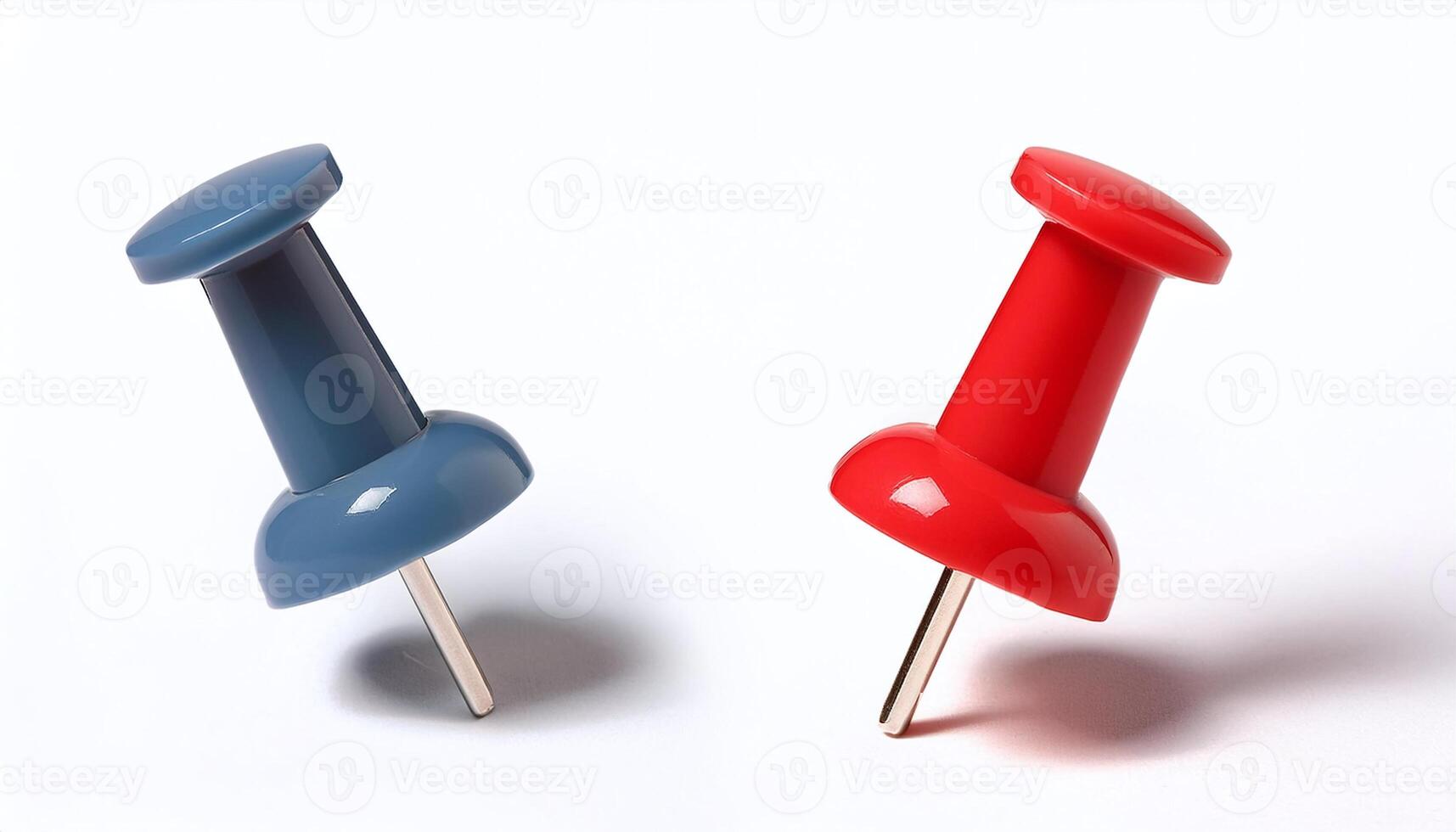 Two red and blue push pins on a white surface photo