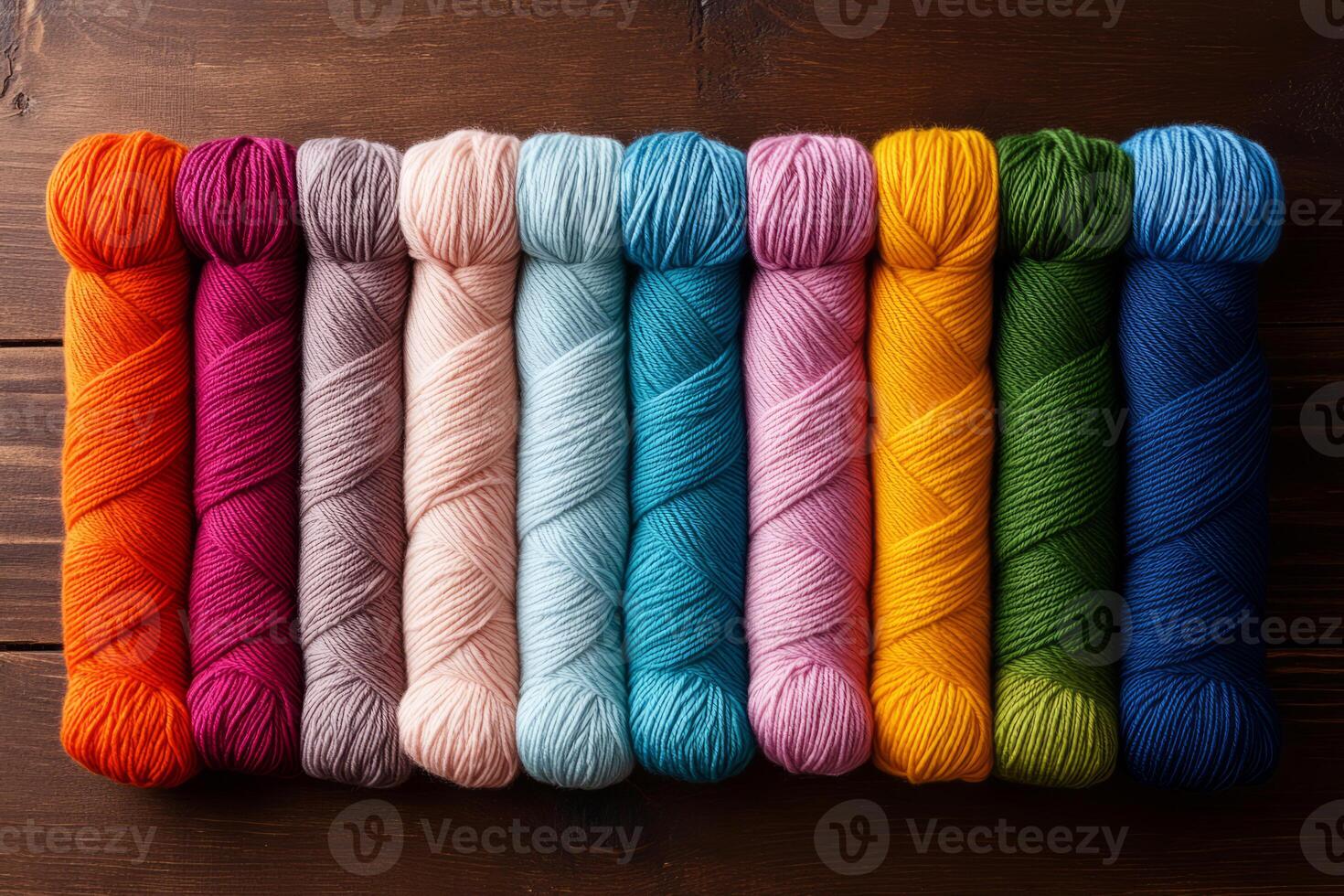 Variety of yarn skeins in different colors on a neutral background photo