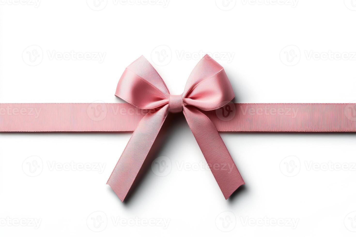 Pink ribbon with a decorative bow on white background photo