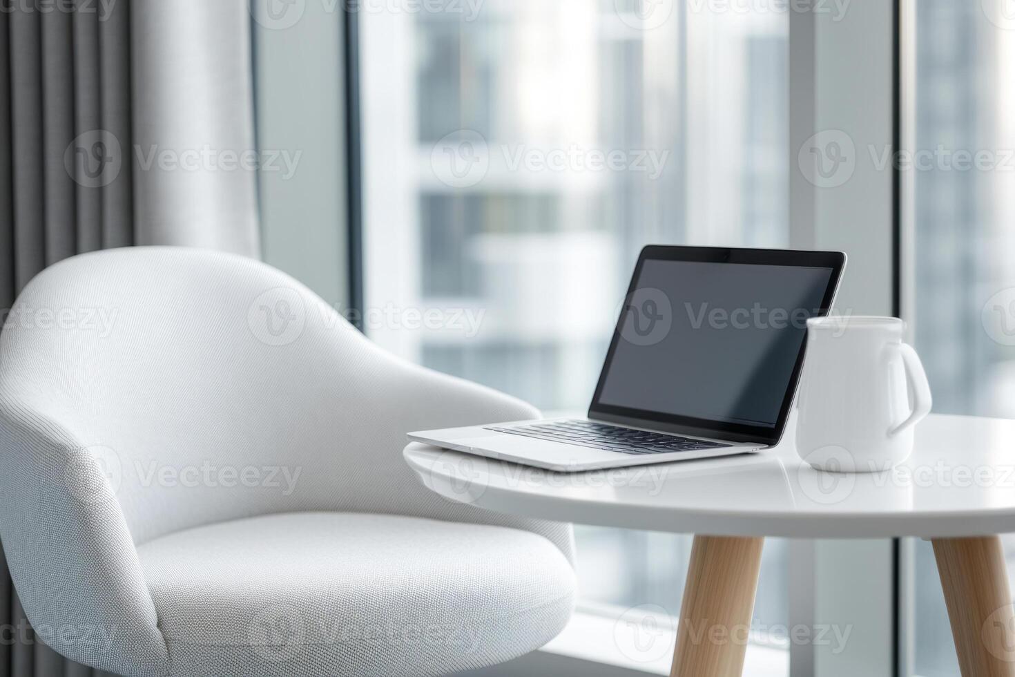 Simple clean home office workspace with a laptop on desk in a bright room photo