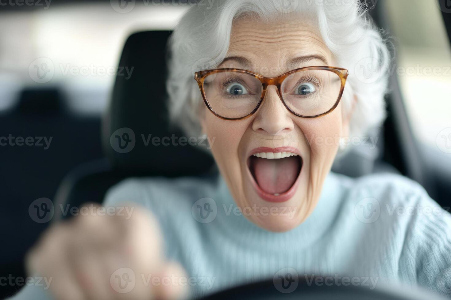 Senior woman with glasses smiles while driving a car photo