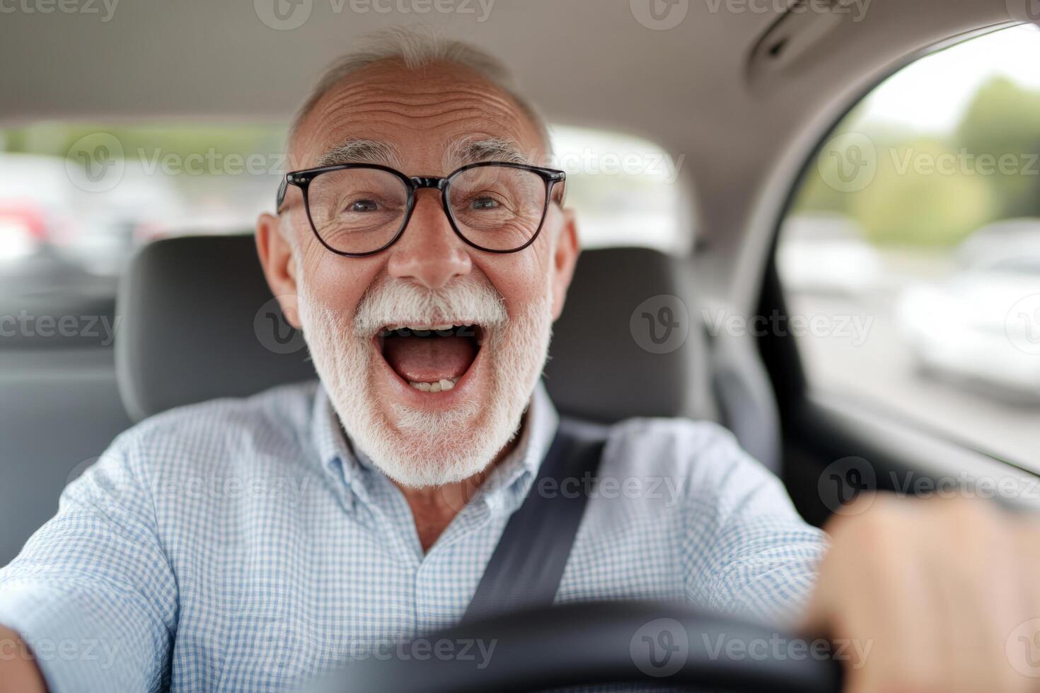 Senior man with glasses smiles while driving a car photo