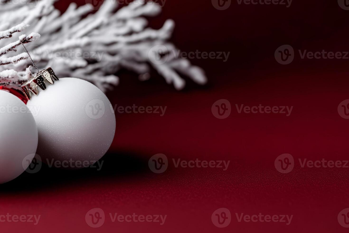 Elegant Christmas decor with snow covered branches on a deep red background photo