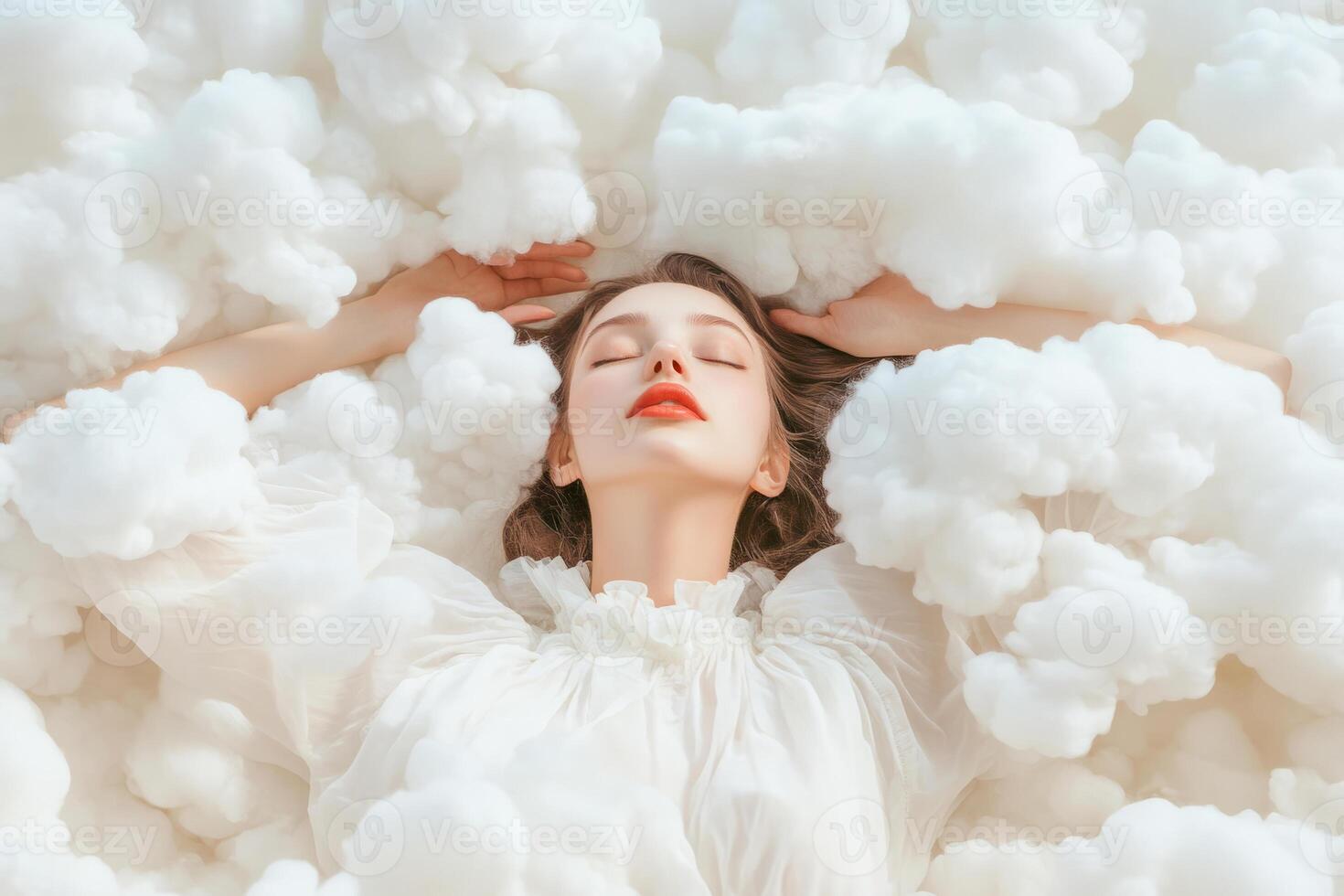 Woman lies among fluffy white clouds. Calm dreamy emotions photo