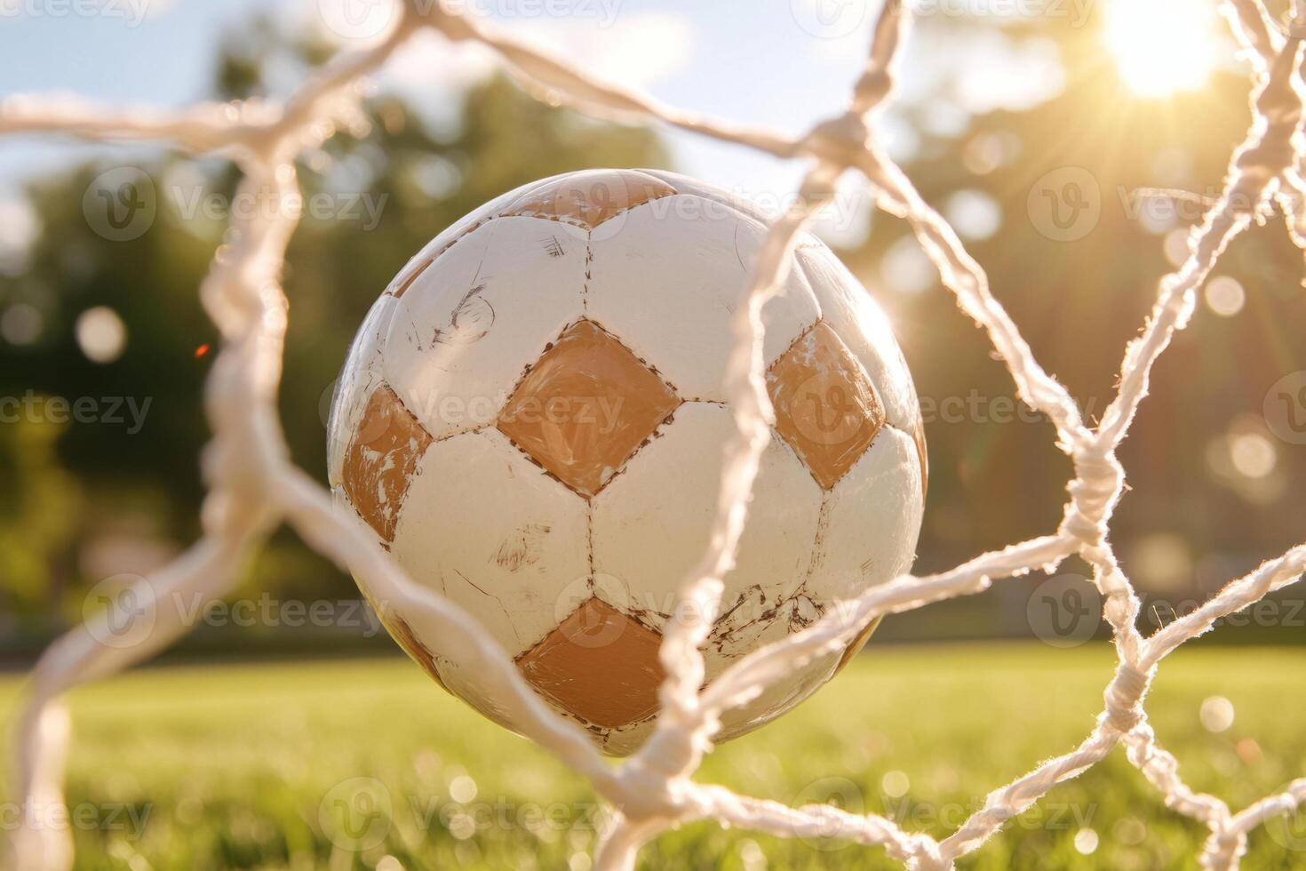 Pink soccer ball hits the net in a goal on a blurred background photo